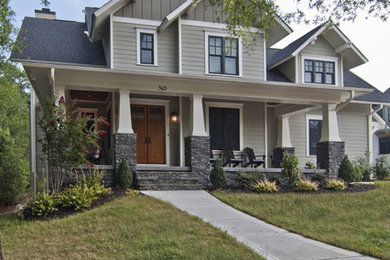 This is an example of a mid-sized arts and crafts two-storey beige house exterior in Charlotte with concrete fiberboard siding, a gable roof and a shingle roof.