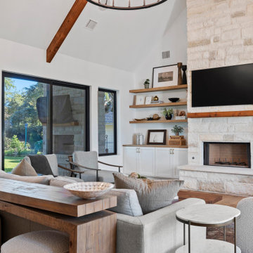 Modern Lakeside Farmhouse Living Room with Stone Fireplace and Vaulted Ceilings