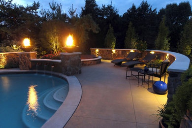 This is an example of a large country backyard garden in Columbus with a water feature.