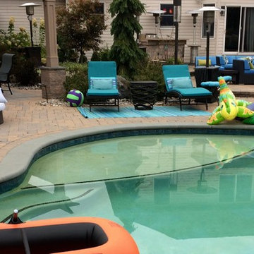Outdoor living space with pool and sunken bar, plus cabana