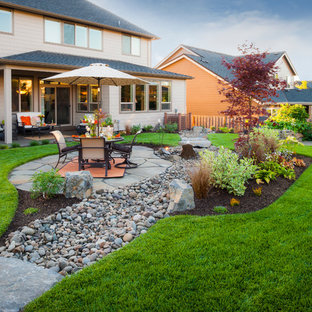 Inspiration for a traditional backyard garden in Portland with river rock.