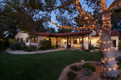 Inspiration for a mid-sized timeless beige one-story stucco exterior home remodel in Santa Barbara with a tile roof