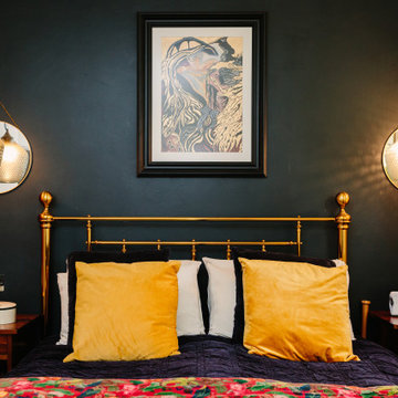 A luxurious master bedroom with gold framed bed