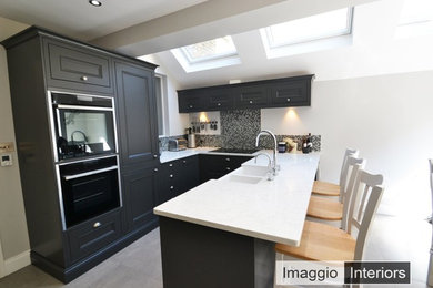 Classic smooth-painted shaker style kitchen with grey toned mosaic splashback