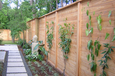 This is an example of a large asian backyard concrete paver landscaping in Dallas.