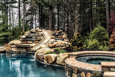 Inspiration for a mid-sized rustic backyard stamped concrete and custom-shaped natural hot tub remodel in Boston