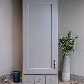 Waypoint Gray Shaker Door Cabinetry with Tiled Shower and Matching Tub Surround