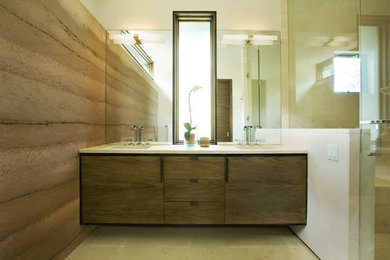 Example of a mountain style alcove shower design in Denver with flat-panel cabinets, dark wood cabinets and an undermount sink