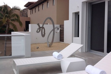 Patio - large contemporary backyard tile patio idea in Orange County with no cover