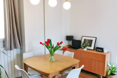 Cette photo montre une salle à manger ouverte sur le salon tendance de taille moyenne avec un mur blanc, parquet clair, aucune cheminée et un sol marron.