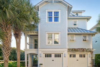 Beach style blue wood and shingle exterior home photo in Wilmington with a metal roof and a gray roof