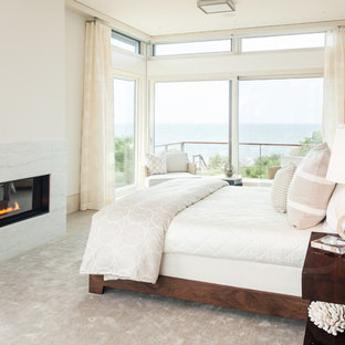 Großes Modernes Hauptschlafzimmer mit weißer Wandfarbe, Gaskamin, Bambusparkett, beigem Boden und Kaminumrandung aus Stein in Boston