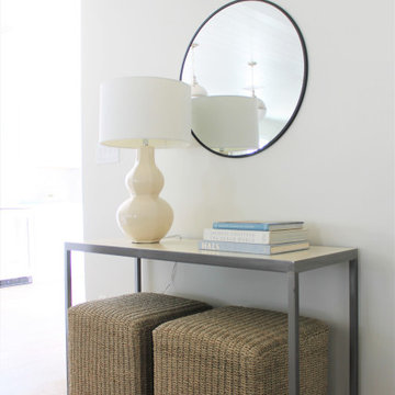 Jute Ottomans Under Coastal Console Table with Round Mirror