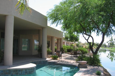 Transitional backyard brick and custom-shaped pool photo in Sacramento