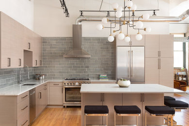 Inspiration for a contemporary l-shaped open plan kitchen in Chicago with an undermount sink, flat-panel cabinets, light wood cabinets, grey splashback, subway tile splashback, stainless steel appliances, medium hardwood floors, with island and brown floor.