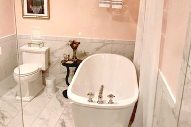 Photo of a small traditional master bathroom in Other with a freestanding tub, yellow walls, marble floors and white floor.