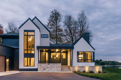 Mid-sized transitional white two-story stucco and clapboard exterior home idea in Minneapolis with a shingle roof and a black roof