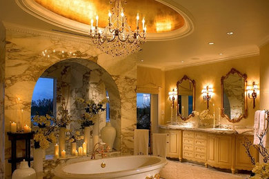 Large traditional master bathroom in Salt Lake City with recessed-panel cabinets, white cabinets, marble benchtops, white tile, beige walls, marble floors, a drop-in sink, a freestanding tub and stone tile.
