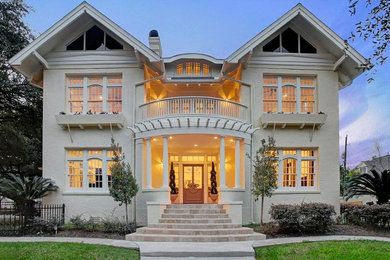 Inspiration for a large victorian beige three-story brick gable roof remodel in Houston