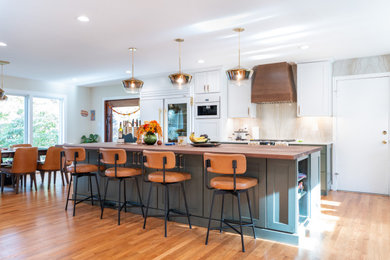Eat-in kitchen - large transitional l-shaped light wood floor and brown floor eat-in kitchen idea in DC Metro with a single-bowl sink, green cabinets, wood countertops, beige backsplash, granite backsplash, white appliances, an island and brown countertops