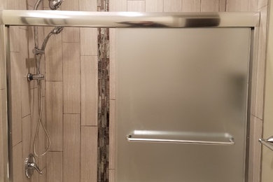 Mid-sized elegant kids' brown tile and ceramic tile ceramic tile bathroom photo in DC Metro with recessed-panel cabinets, black cabinets, a one-piece toilet, beige walls, a wall-mount sink and granite countertops