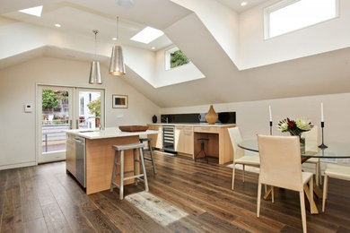 Eat-in kitchen - mid-sized contemporary u-shaped porcelain tile and brown floor eat-in kitchen idea in San Francisco with an undermount sink, flat-panel cabinets, light wood cabinets, quartz countertops, black backsplash, stone slab backsplash, paneled appliances, an island and white countertops