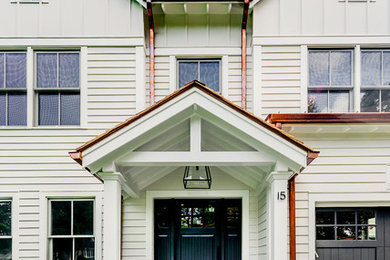 Example of a mid-sized white three-story wood gable roof design in New York