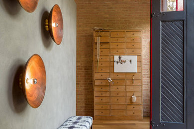 Inspiration for a transitional medium tone wood floor, brown floor and brick wall entryway remodel in Chicago with gray walls and a black front door