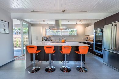 Photo of a large modern l-shaped separate kitchen in San Francisco with an undermount sink, flat-panel cabinets, brown cabinets, quartz benchtops, stainless steel appliances, concrete floors, with island and grey floor.