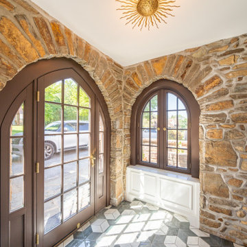 Custom Stone Entry Vestibule with Arched Door