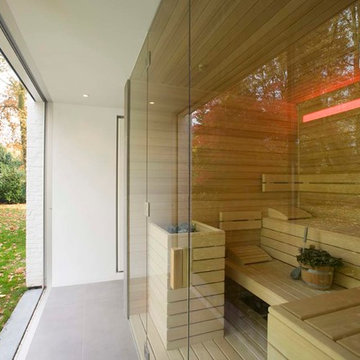 Bespoke sauna with glass fronting, looking out onto garden