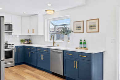Example of a small u-shaped vinyl floor and brown floor eat-in kitchen design in San Francisco with a single-bowl sink, shaker cabinets, blue cabinets, quartz countertops, white backsplash, ceramic backsplash, stainless steel appliances and white countertops