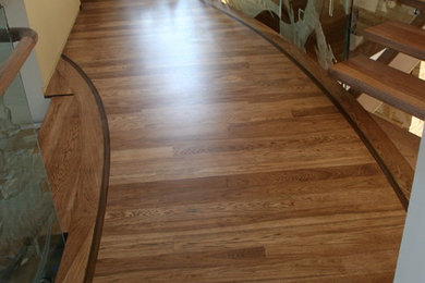 Inspiration for a contemporary wooden floating staircase remodel in Las Vegas with glass risers