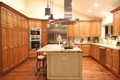 Example of a large classic u-shaped medium tone wood floor and beige floor open concept kitchen design in San Diego with an undermount sink, recessed-panel cabinets, light wood cabinets, quartzite countertops, white backsplash, stone slab backsplash, stainless steel appliances, an island and white countertops
