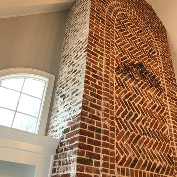 German Schmear on two story brick fireplace