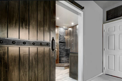 This is an example of a mid-sized traditional master bathroom in Dallas with recessed-panel cabinets, dark wood cabinets, a claw-foot tub, a corner shower, grey walls, light hardwood floors, an undermount sink, white floor and a hinged shower door.