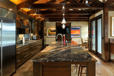 Open concept kitchen - large rustic l-shaped light wood floor open concept kitchen idea in Vancouver with an undermount sink, flat-panel cabinets, dark wood cabinets, stainless steel appliances and an island