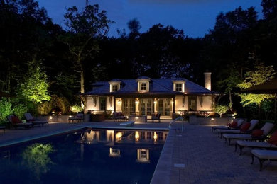 Inspiration for a large timeless beige two-story stucco exterior home remodel in Milwaukee with a clipped gable roof