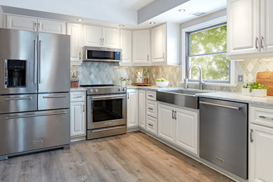 Example of a huge transitional l-shaped vinyl floor and beige floor eat-in kitchen design in Other with a farmhouse sink, raised-panel cabinets, white cabinets, quartz countertops, multicolored backsplash, ceramic backsplash, stainless steel appliances, an island and gray countertops