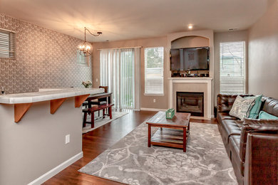Inspiration for a small transitional enclosed laminate floor living room remodel in Seattle with gray walls