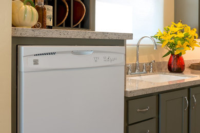 Example of a mid-sized transitional galley vinyl floor open concept kitchen design in San Diego with an undermount sink, shaker cabinets, green cabinets, quartz countertops, white appliances and no island