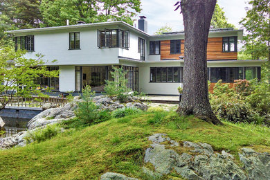Inspiration for a modern mixed siding flat roof remodel in Boston