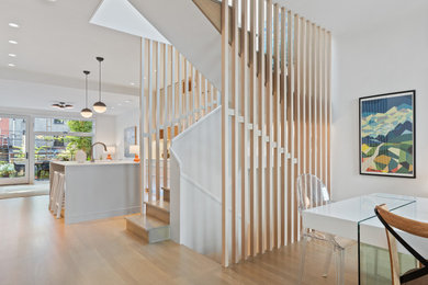 Example of a mid-sized trendy wooden u-shaped wood railing staircase design in New York with wooden risers