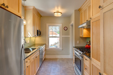 Inspiration for a timeless galley ceramic tile and beige floor enclosed kitchen remodel in Other with an undermount sink, shaker cabinets, light wood cabinets, marble countertops, green backsplash, glass tile backsplash, stainless steel appliances and no island
