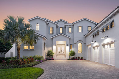 Large transitional gray two-story concrete exterior home idea with a gray roof