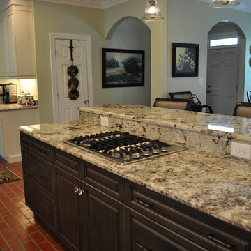 Brush-stroke painted kitchen with red brick floor