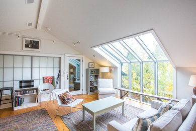 Example of a mid-sized trendy formal and enclosed medium tone wood floor and brown floor living room design in Other with white walls, no fireplace and no tv