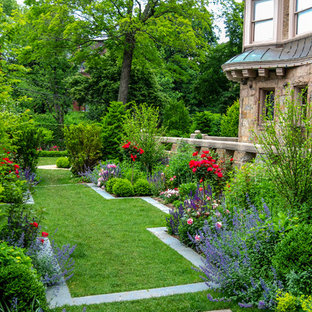 Inspiration for a mid-sized traditional backyard full sun formal garden for summer in Boston with natural stone pavers and with lawn edging.