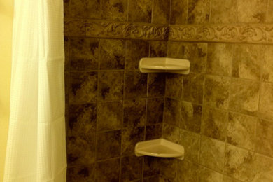 Inspiration for a brown tile and ceramic tile bathroom remodel in Dallas with beige walls