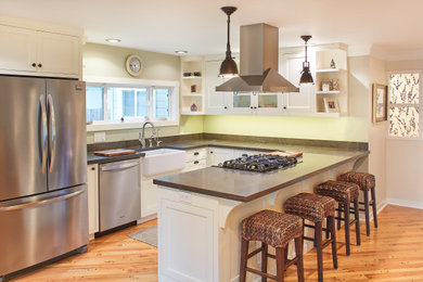 Large arts and crafts l-shaped light wood floor and brown floor eat-in kitchen photo in Other with a farmhouse sink, shaker cabinets, white cabinets, soapstone countertops, black backsplash, stone slab backsplash, stainless steel appliances and black countertops